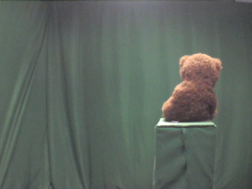 Brown Teddy Bear Wearing Red Ribbon